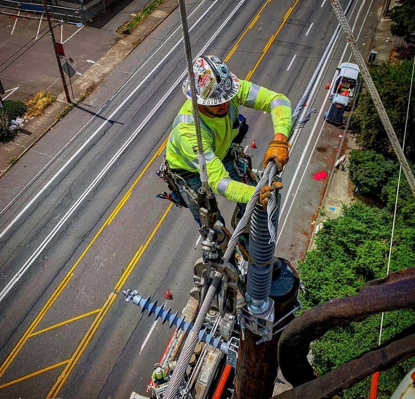 Apprentice lineman seen from above, street far below