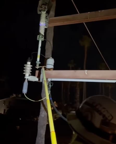 Lineworker using a hot stick