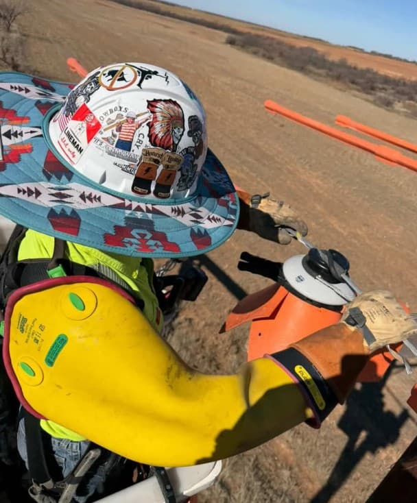 Lineworker dressing a knot in rigging