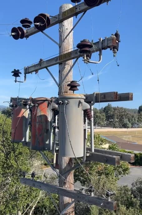 Weathered transformer bank on an old distribution pole