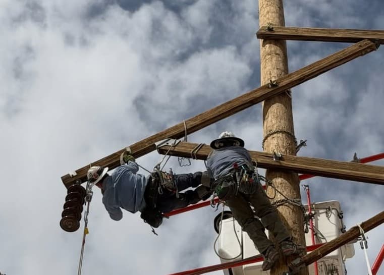 Lineworkers working from a pole