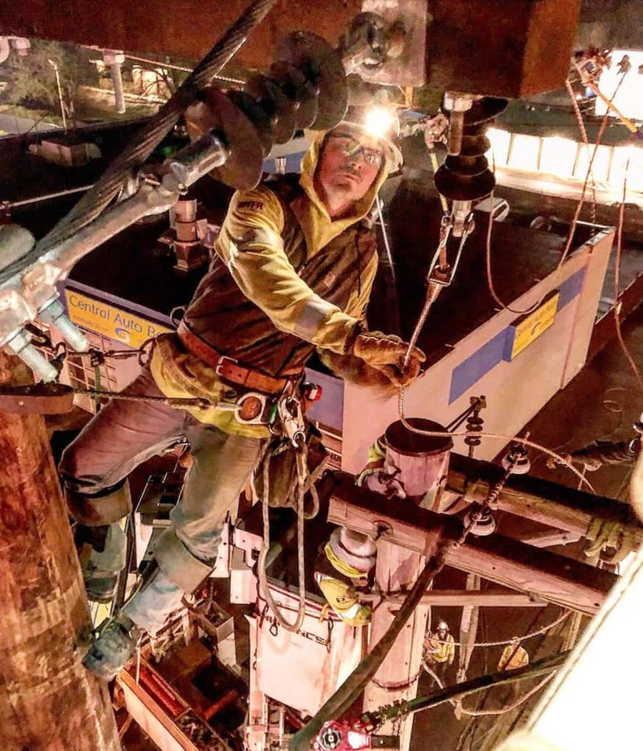Line crew working under lights at night